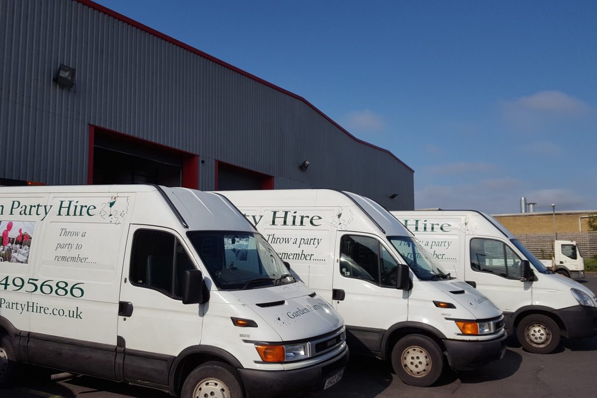 Three Garden Party Hire branded van outside a warehouse